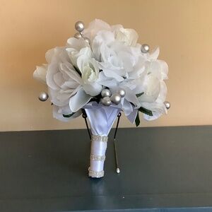 White roses, white rosebuds and silver berries bridal bouquet